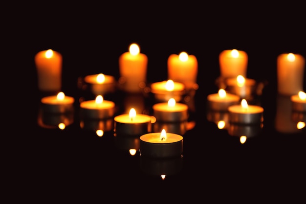 Burning candles on dark background