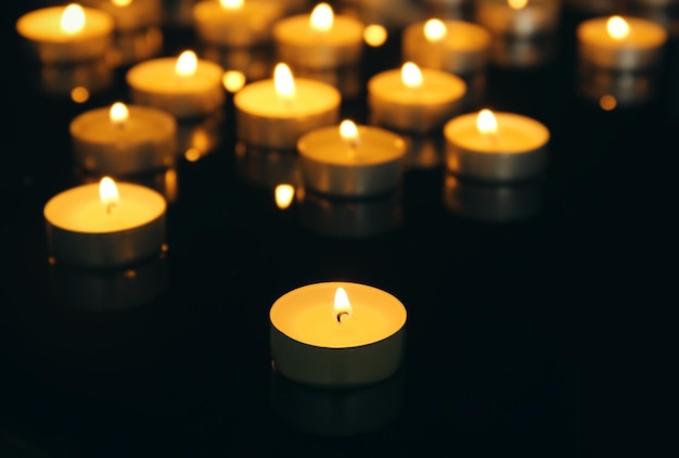 Burning candles on dark background