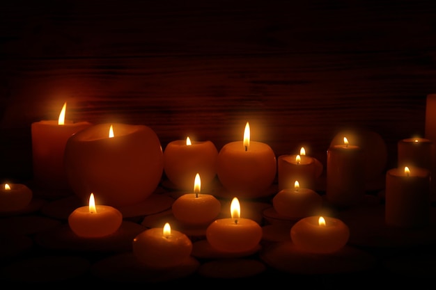 Burning candles on dark background