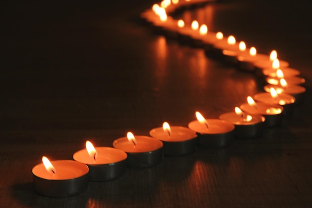 Burning candles on dark background