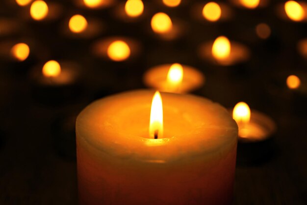 Burning candles on dark background