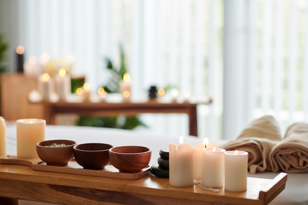 Burning Candles and Herbs on Table