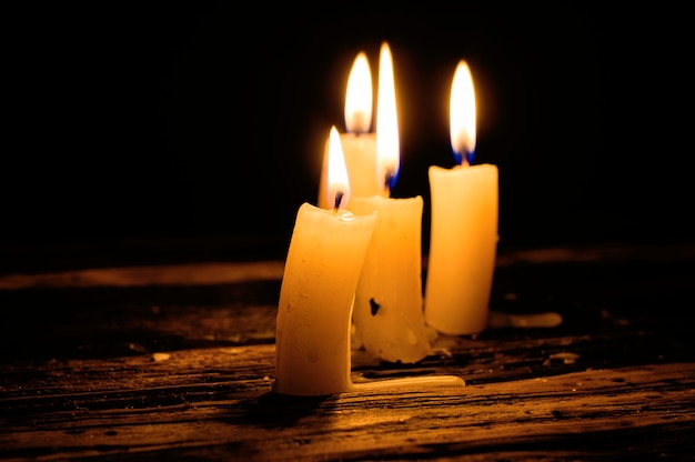 burning candles near the book on the table