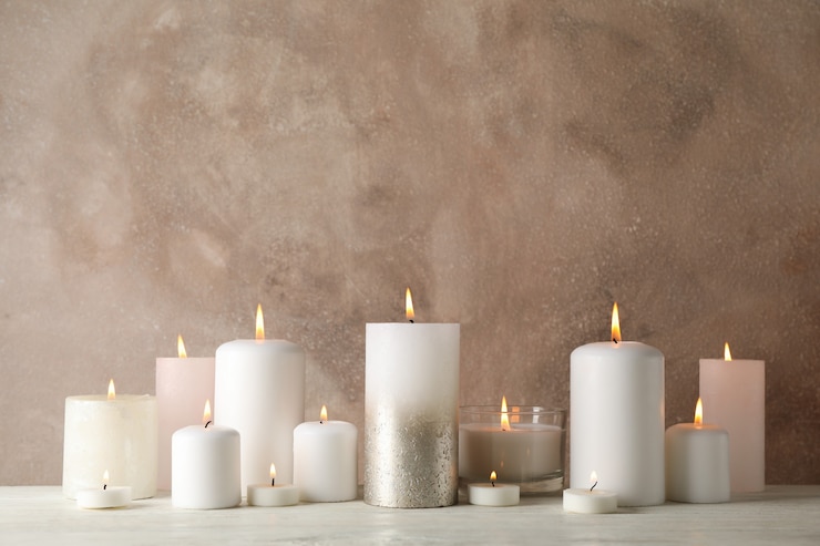 Photo burning candles on white wooden table on brown