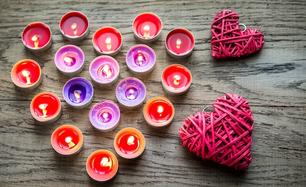 Burning candles with retro cane hearts