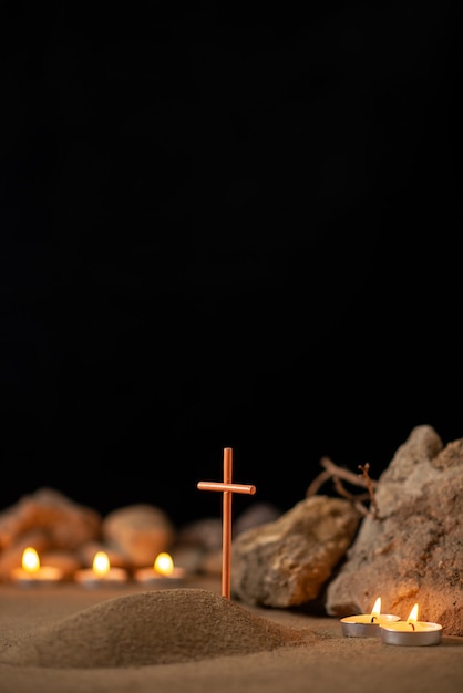 Photo burning candles with stones around little grave as memory death funeral