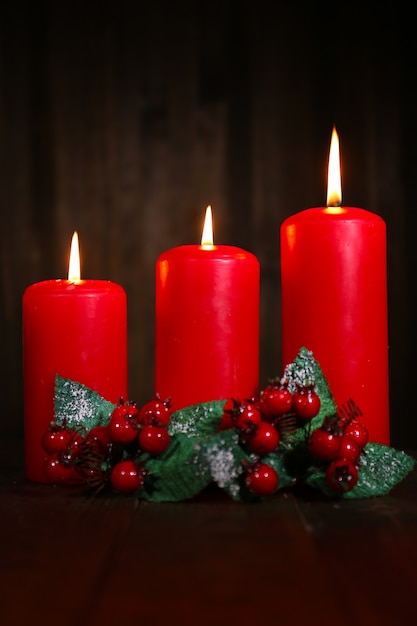 Burning candles on wooden background