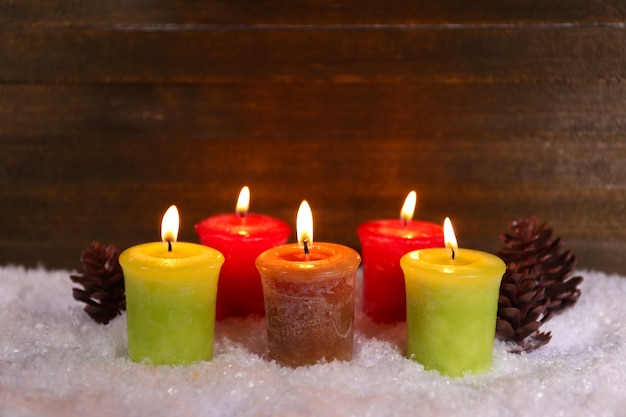 Burning candles on wooden background