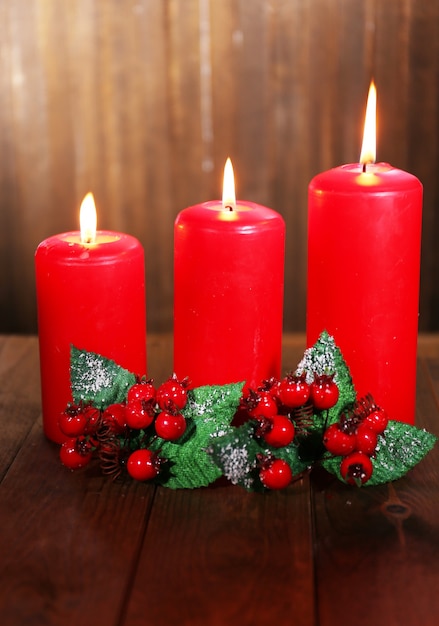 Burning candles on wooden table