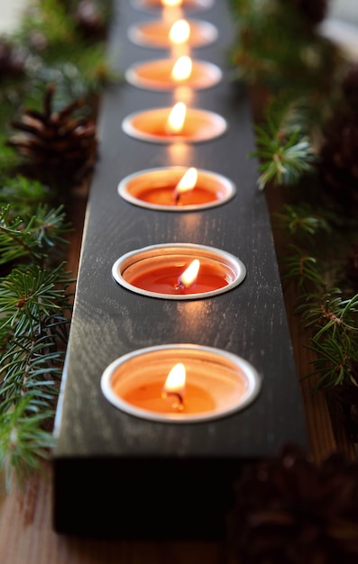 Burning christmas candles. Decorative ornaments.