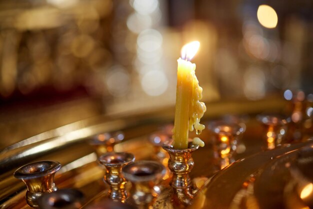 Burning church candles near the altar closeup