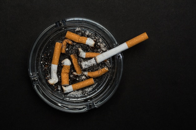 Burning cigarette left in ashtray