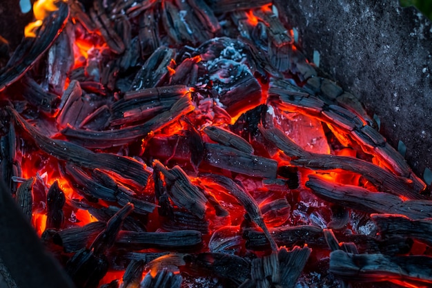Burning coals. Decaying charcoal. Texture embers closeup. burning charcoal in the background. 