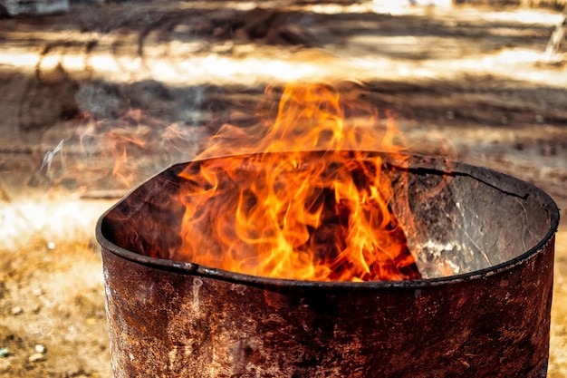 Burning fire in a barrel closeup Bright flame Open flame heating Problems with heating and gas