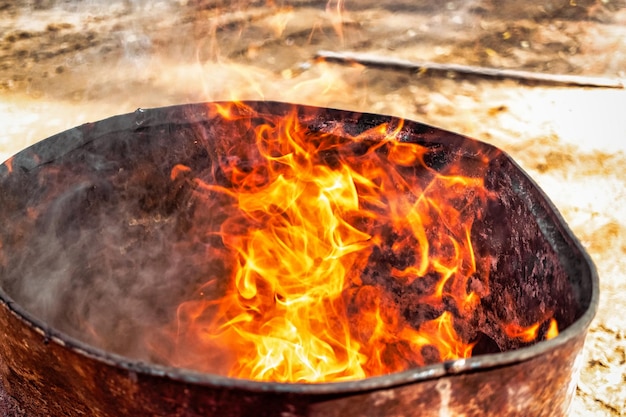 Burning fire in a barrel closeup Bright flame Open flame heating Problems with heating and gas