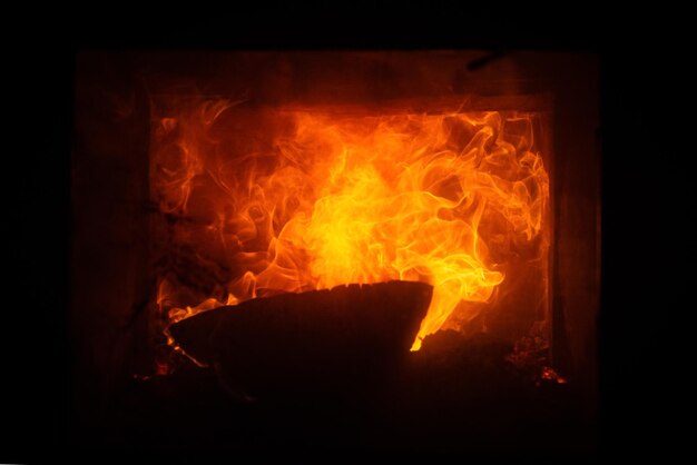 Burning fire. Glowing fireplace logs. Coziness warm christmas time.
