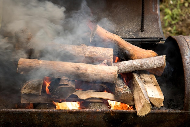 Burning firewood in an iron brazier smoke and fire