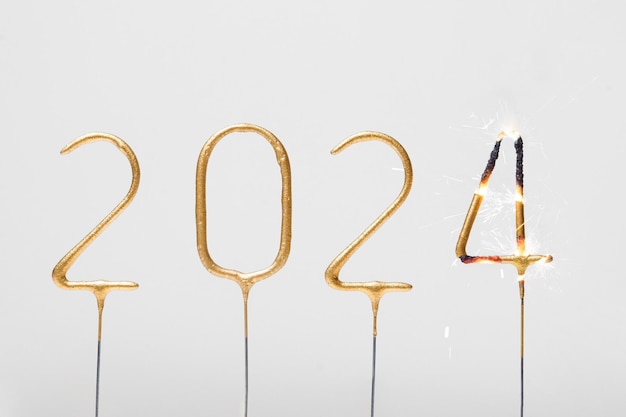 burning golden numbers 2024 sparklers on gray isolated background celebration of the new year and wishes for success