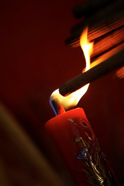 Burning incense sticks on red candle to celebrate the traditional wedding in Chinese