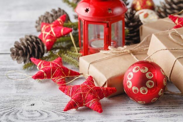 Burning lantern and christmas decoration on white table