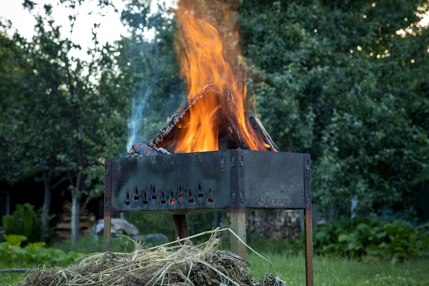 Burning logs in a brazier. Picnic time.