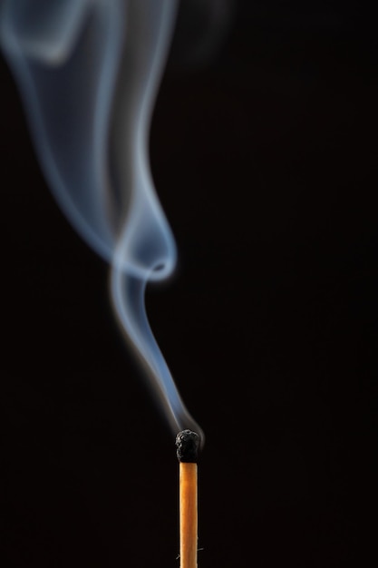 burning match on black background