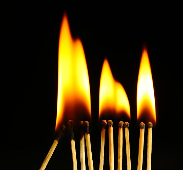 Burning matches on black background