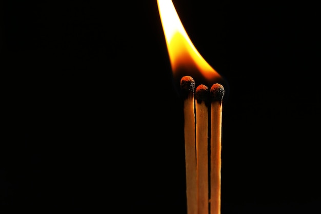 Burning matches on dark background