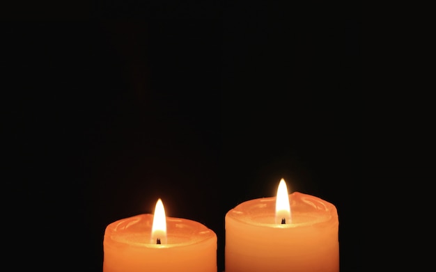 Burning Pair of Orange Candles On Black Background