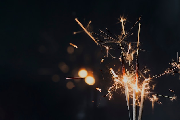 Burning sparkler on dark background at night