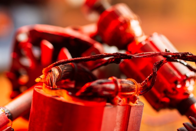 Burning wires on the details of an electrical appliance on a wooden table in a repair shop