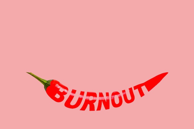 Burnout creative word on red chili pepper Pink isolated background