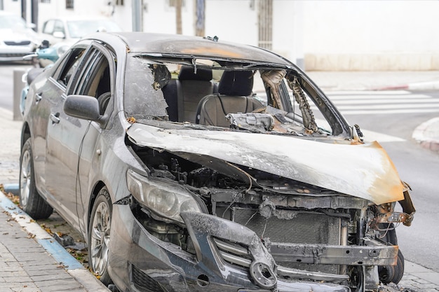 Burnt hood of a passenger car. Arson of a car.