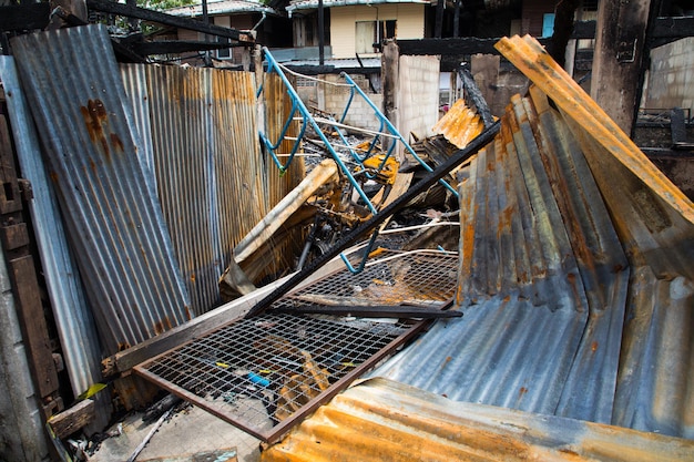 Burnt out house with charred roof trusses and burnt furniture