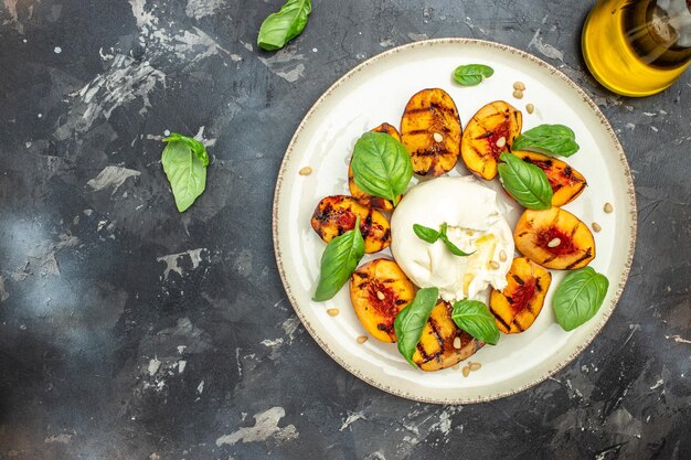 Burrata cheese and grilled peaches with rose wine top view place for text