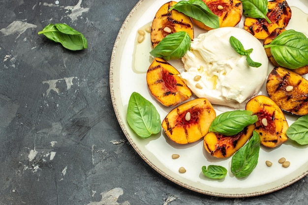 Burrata cheese and grilled peaches with rose wine top view place for text