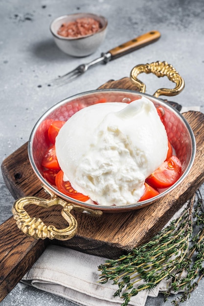 Burrata Italian cheese made from cream and milk of buffalo or cow Gray background Top view