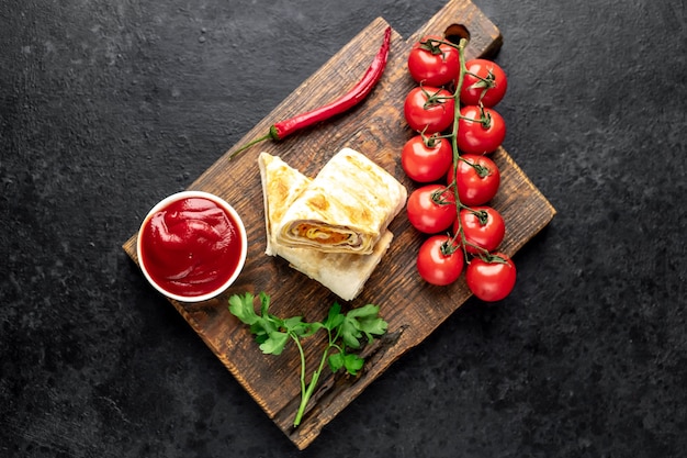 Burrito rolls with ham and cheese on a concrete table