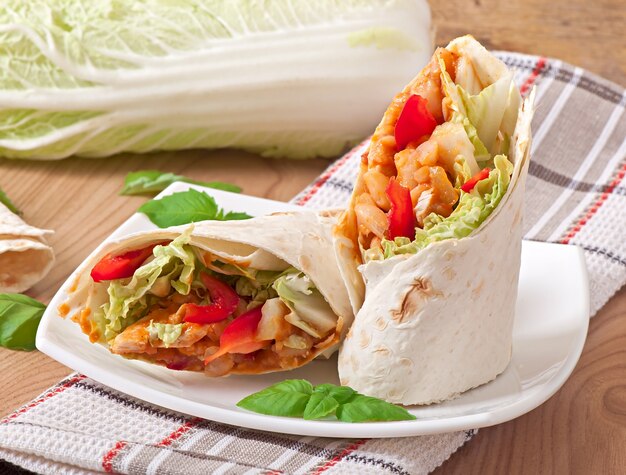 Burrito with chicken, beans, tomatoes and sweet peppers