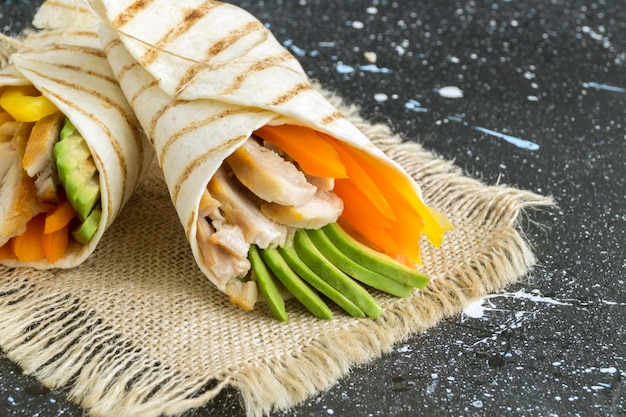 Burrito with grilled chicken and vegetables (fajitas, pita bread, Shawarma)