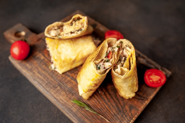 Burrito wraps with chicken and vegetables , against a background of concrete, Mexican shawarma