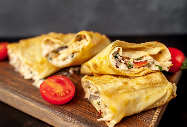 Burrito wraps with chicken and vegetables , against a background of concrete, Mexican shawarma