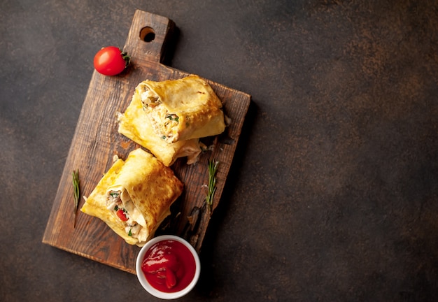 Burrito wraps with chicken and vegetables , against a background of concrete with copy space for your text, Mexican shawarma