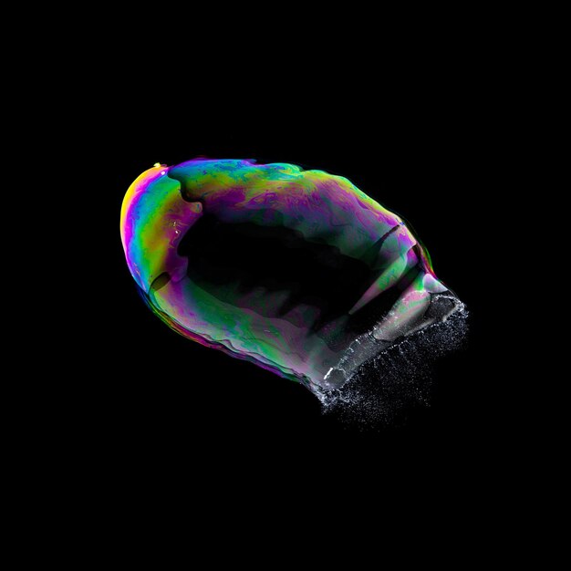 Взрыв мыльного пузыря в ярких цветах на черном фоне