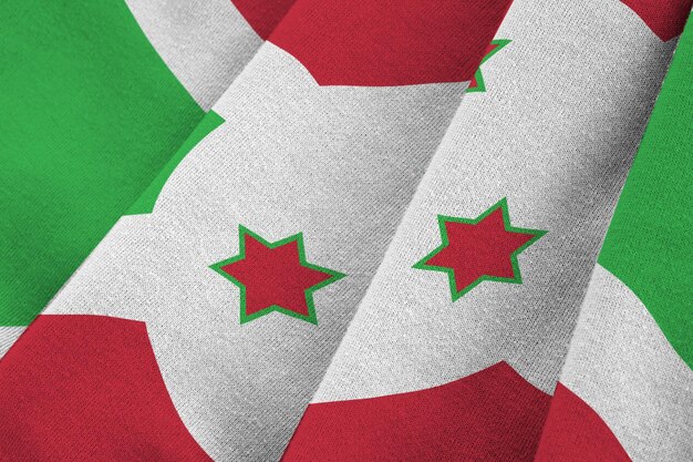 Burundi flag with big folds waving close up under the studio light indoors The official symbols and colors in banner