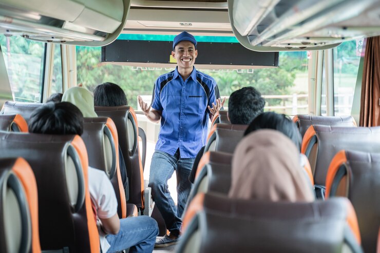 https://img.freepik.com/premium-photo/bus-crew-uniform-hat-smiling-while-briefs-passengers-bus-before-leaving_8595-22024.jpg?w=740