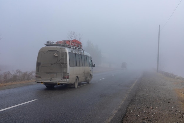 Bus in foggy weather with low poor visibility on a road in swat valley Pakistan