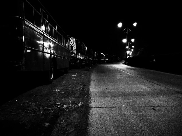 Photo buses parked by street at night