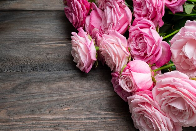 Bushy pink roses on a natural wooden background