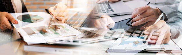 Business accountant working on desk using mobile phone and calculator to calculate budget concept finance and accounting in morning light